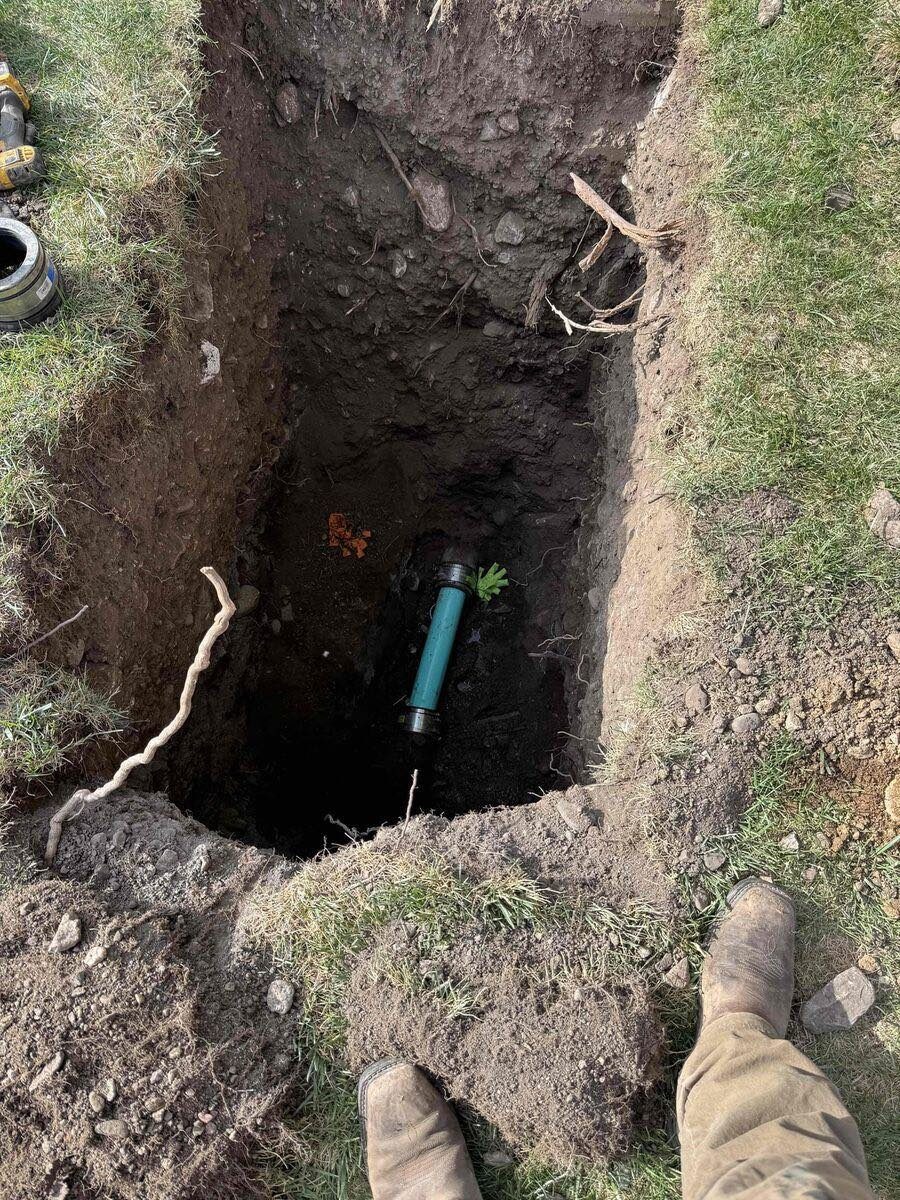 Green sewer pipe in a deep excavation in Utah