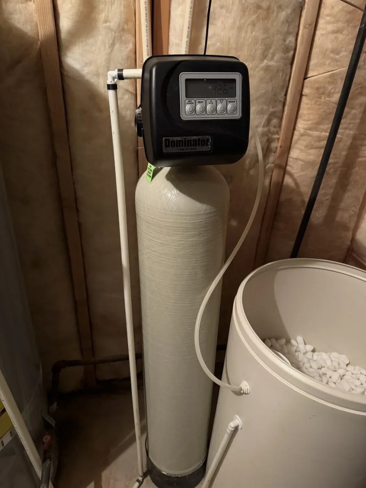 Water softener and brine tank installed by Rare Breed Plumbing in a Utah basement