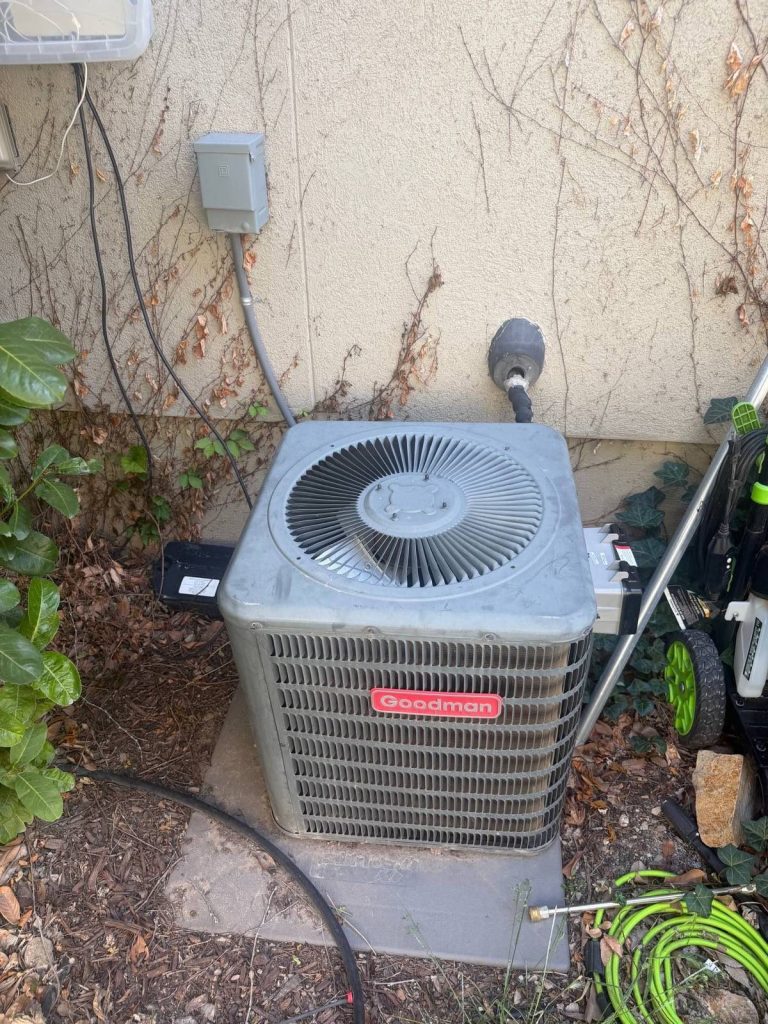 Weathered outdoor air conditioning condenser unit beside a Utah home