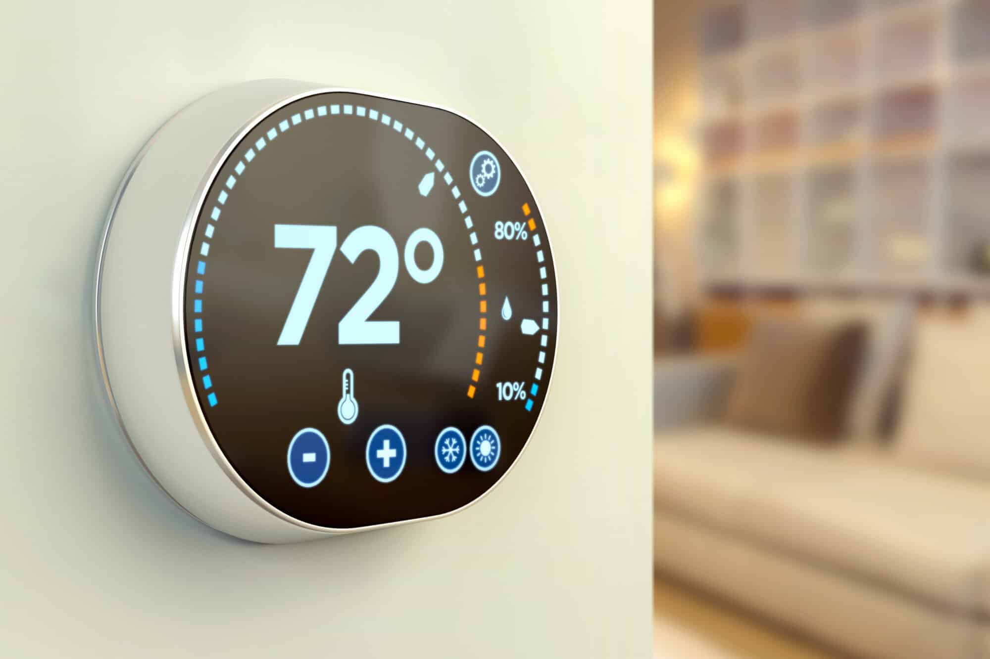 Product rendering of a round smart thermostat set to 72 degrees on a wall
