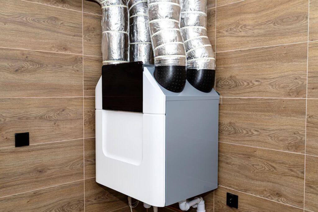 Wall mounted energy recovery ventilator with insulated ducts
