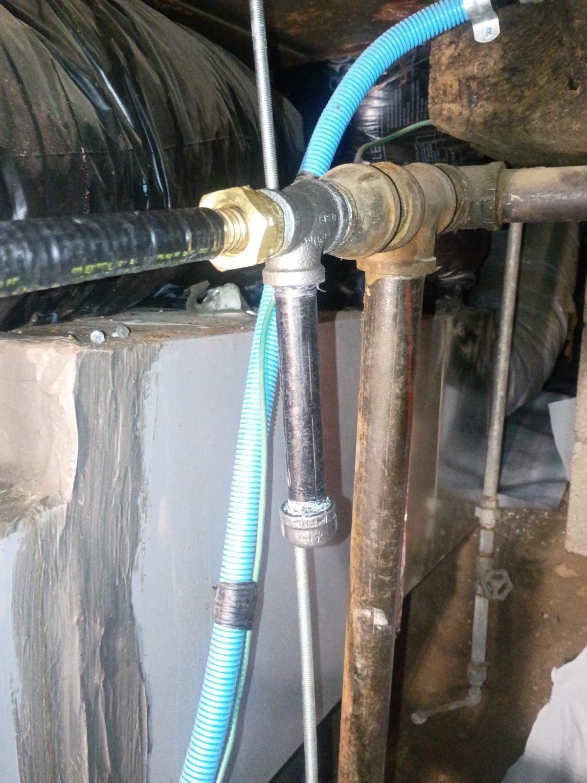 Water and gas piping with a flexible connector in a crawlspace