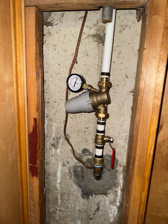 Pressure reducing valve and gauge on a main water line in a Utah home