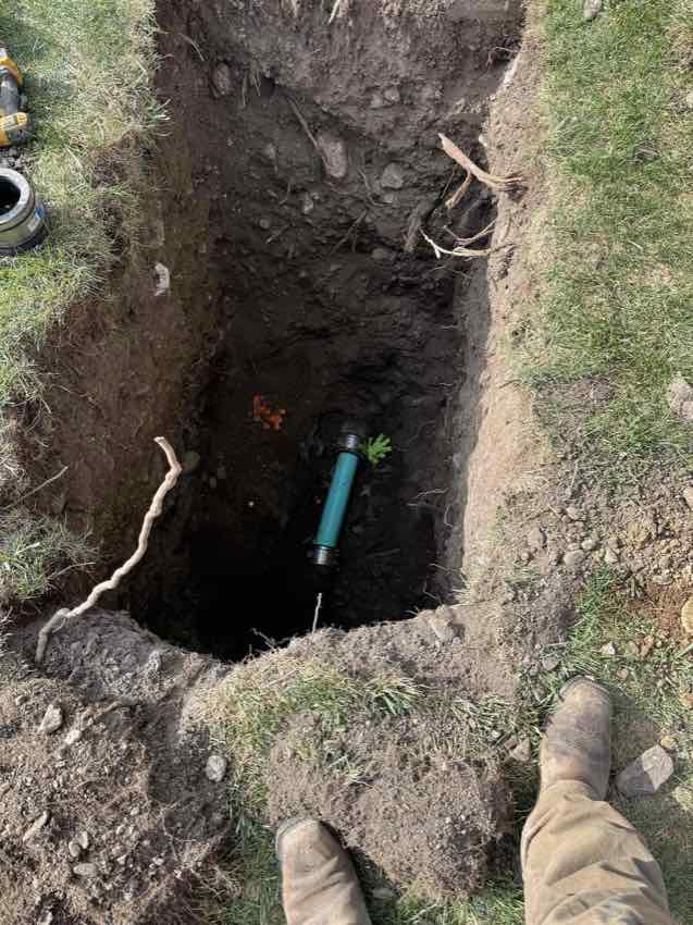 Deep excavation exposing a sewer line in Utah