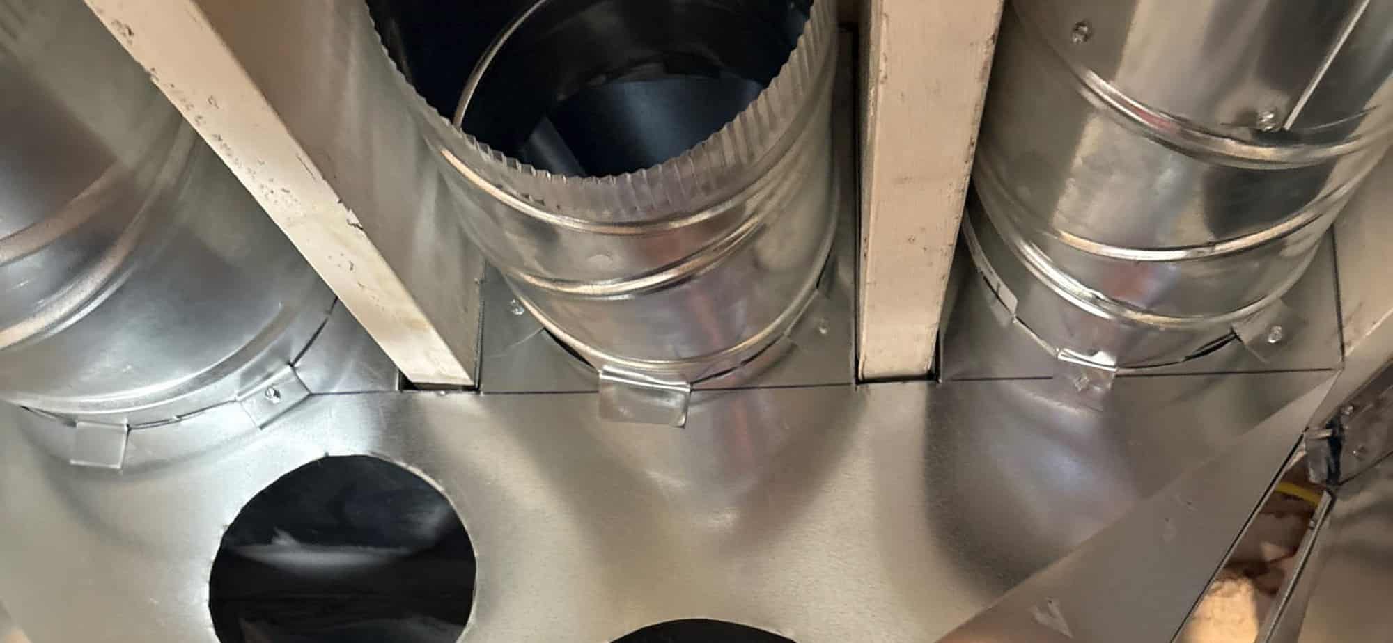 New galvanized ductwork with round supply takeoffs installed in a Utah home