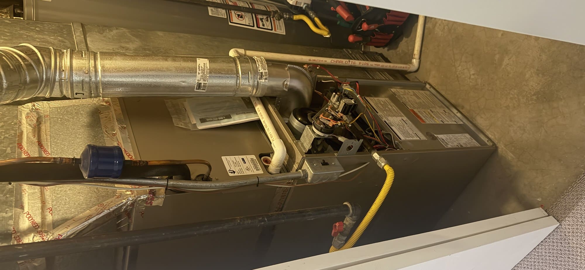 Gas furnace with the service panel open showing the gas line and controls in a Utah home