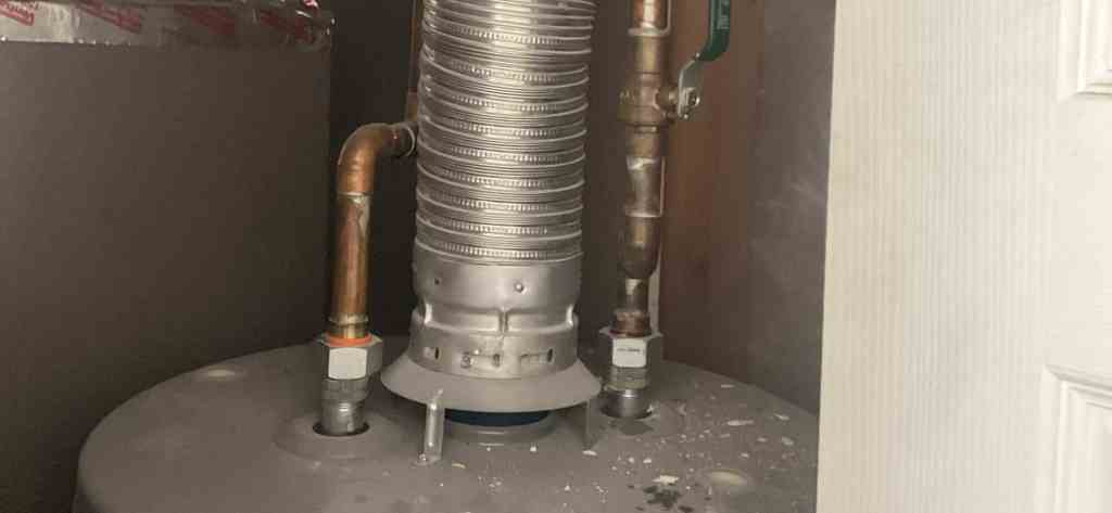 Water heater flue and copper supply connections in a Utah utility closet